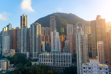 Fototapeta na wymiar City view of Skyscrapers building Hong Kong city, cityscape flying above Hong Kong City development buildings, Residential area against the backdrop of hills and mountains.