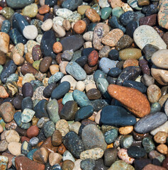 Colorful stones on the seashore or ocean. Different types of minerals.