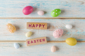 Festive Easter: Colorful Eggs and Wooden Blocks with words Happy Easter - 757243387