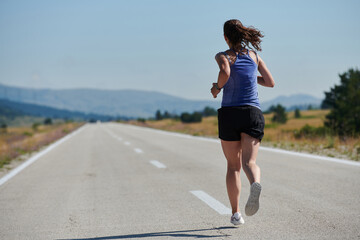 A determined woman athlete trains for success in the morning sun.