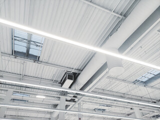 Ceiling in an industrial room, warehouse, mall with an exhaust and air circulation system