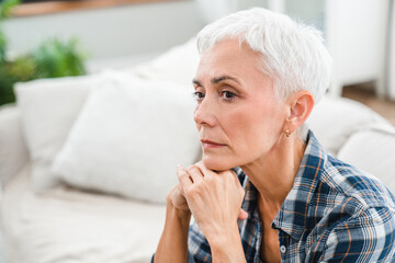 Sad depressed mature woman thinking about negativity and problems at home. Middle-aged woman...