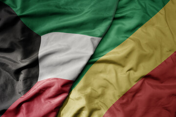 big waving national colorful flag of republic of the congo and national flag of kuwait.