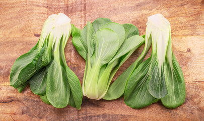Bok choy or chinese cabbage on wooden background. View above. - 757257535