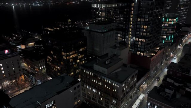 Aerial view of skyscrapers and streets of a night city with crossroads and car traffic Halifax, Canada. Cinematic aerial shot of a modern city at night with skyscrapers.