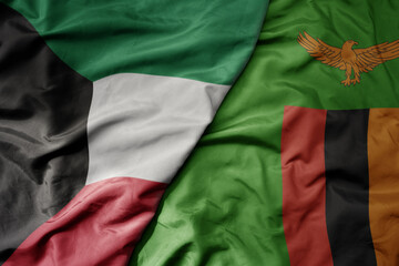 big waving national colorful flag of zambia and national flag of kuwait.