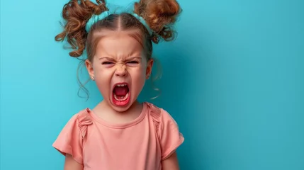 Fotobehang Playful child with pigtail hairstyles on a blue background © Mustafa