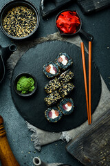 Sushi roll with tuna, salmon and cheese. Asian cuisine. Close up. Free space for your text.