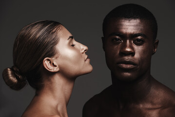 Interracial couple, face or love in skincare, dermatology or beauty as health, support or wellness. Black man, woman or glow as creative, aesthetic or diversity in bonding together on grey background