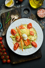 Traditional Caesar salad with chicken. Close-up, dark background.