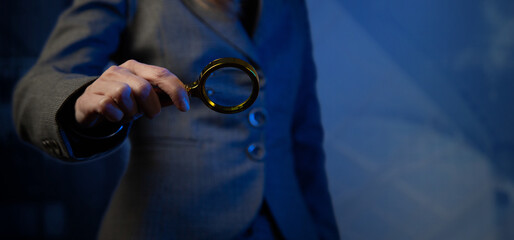 Cg tech collage. A female hand holds a magnifying glass against the background of a silhouette in a...
