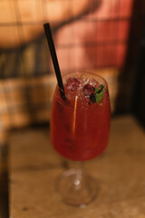 Glass with straw filled with alcohol cocktail on table. Visual feast for guests seeking refreshing drink during party time