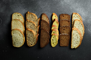 Slices of different types of bread. Assortment of rye, bran and sourdough bread. Top view.