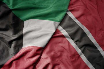 big waving national colorful flag of trinidad and tobago and national flag of kuwait.