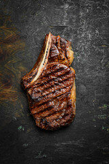 Steak. Grilled steak on the bone. Roasted piece of meat. Free space for text.