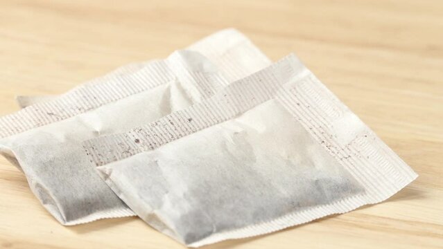 paper bags with tea on wooden board