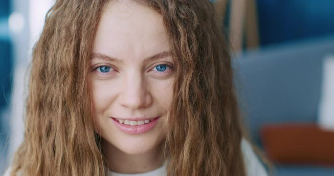 Close up shot of female face. Pretty blonde hair female. Face of woman with blue eyes. Perfect skin woman portrait. Close up view of female with no makeup. Beautiful lady gaze with blue eyes.