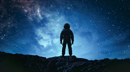 Photo sur Aluminium brossé UFO Silhouette of an astronaut standing on the edge against starry sky with Milky Way and galaxies, blue color background,  astronaut man space exploration concept
