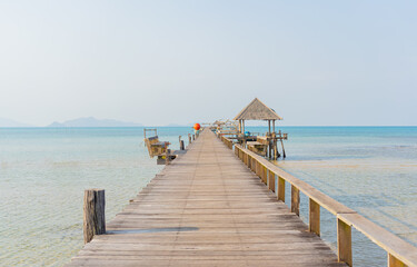 View of the wooden bridge extending into the sea of Koh Mak, Thailand.