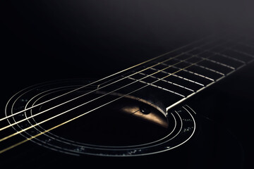 black guitar concept. black guitar in the dark