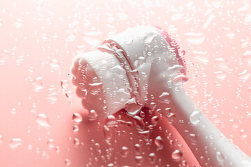 Brush for washing and cleaning the face with drops of water. Hygienic device. Female beauty.