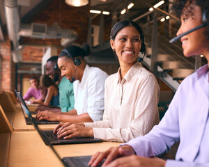 Multi-Cultural Customer Support Or Telesales Team In Modern Open Plan Office Wearing Headsets - 757299711