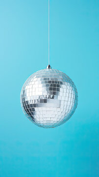 Glistering Silver Disco Ball. on blue pastel background