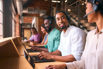 Multi-Cultural Customer Support Or Telesales Team In Modern Open Plan Office Wearing Headsets - 757301941