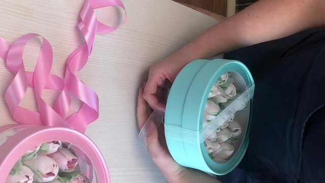 The woman bandages the marshmallow ribbon in a hat box. Tulips from marshmallows. Homemade marshmallows. Vertical video.