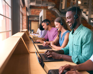 Multi-Cultural Customer Support Or Telesales Team In Modern Open Plan Office Wearing Headsets - 757302751