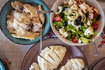 Greek Village Salad, umplings sprinkled with cheese and Halloumi cheese in restaurant in Cyprus island country