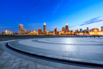 City Square floor and Shanghai skyline with modern buildings at night. Famous Bund landmark in...