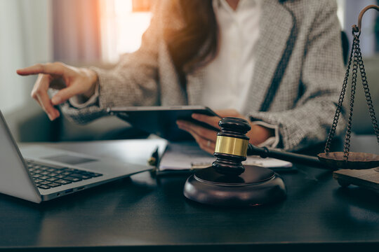 Female lawyer working in office or court with hammer and scale, justice on table, online legal advice, lawyer, consultant, justice and law, lawyer concept, close-up image