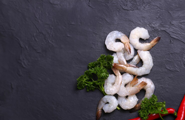 fresh raw peeled shrimps on black background