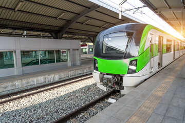 Fototapeta premium Suburban high speed passenger train arrives stop at the station. The concept of modern comfortable fast passenger transportation in the region