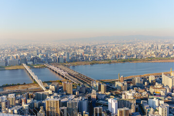 Aerial view of Osaka city and Yodo river and bridges from Umeda Sky Building, Japan. - obrazy, fototapety, plakaty