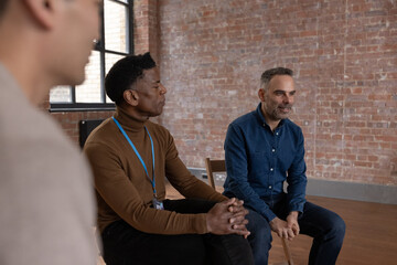 Mature male speaking in a men only group therapy session