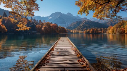 Wooden pier on autumn lake in Alps. Snowy mountains and orange trees on background. Landscape photography - obrazy, fototapety, plakaty