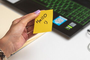 Women holding Hello sticky note, nice wish work business concept desk computer keyboard
