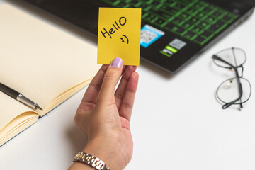 Women holding Hello sticky note, nice wish work business concept desk computer keyboard