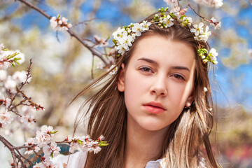 Young beautiful woman in a blooming garden