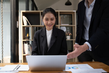 Mature executive helping new employee, Mentor, manager and teamwork with a business man training a female employee.