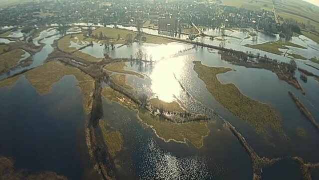 Aerial view of the backwaters of the Narew River in Tykocin on a sunny,spring day..An anamorphic effect is visible in the image -a blue flare.