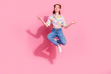 Abwaschbare Fototapete Full length photo of inspired girlfriend redhair young lady jumping balance meditation retreat lotus pose isolated on pink color background © deagreez