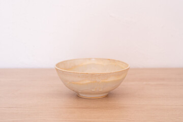 Handmade ceramic bowl, white and beige, wooden. High quality photo