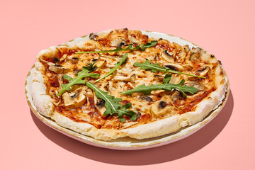Gluten-free pizza with mushrooms and tomatoes on a stylish plate with a pink backdrop