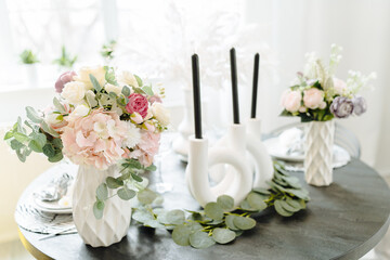 wedding decoration  at the restaurant. Wedding romantic dinner table settings in light pastel colors. Restaurant veranda decorated for wedding celebration with the use of flowers
