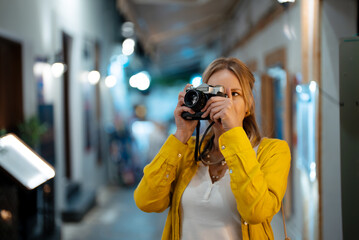 Woman tourist with vintage camera in the old town. - 757349549
