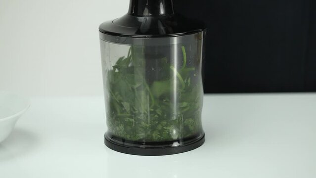 griding parsley with hand blender