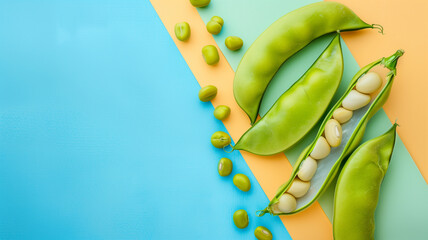 Fresh peas and pea pods on blue and yellow background